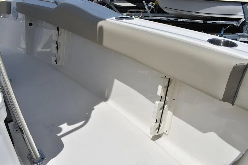 Slide: The Image of 2024 Key West 219 FS boat interior with cushioned side rail and rod holders. - 33