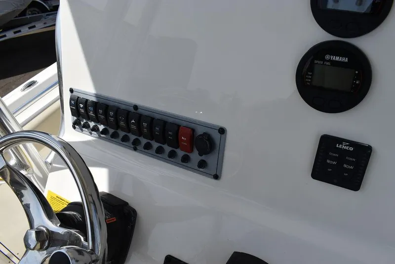 Slide: The Image of 2024 Key West 219 FS boat dashboard with control panel and steering wheel. - 42