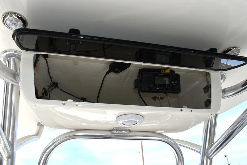Slide: The Image of 2024 Key West 219 FS boat console with electronics and storage. - 43