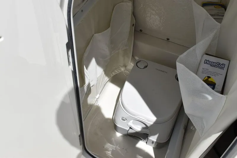 Slide: The Image of 2024 Key West 219 FS boat interior with portable toilet. - 44