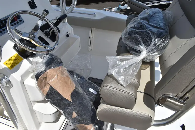 Slide: The Image of 2024 Key West 219 FS boat cockpit with steering wheel and seats. - 45