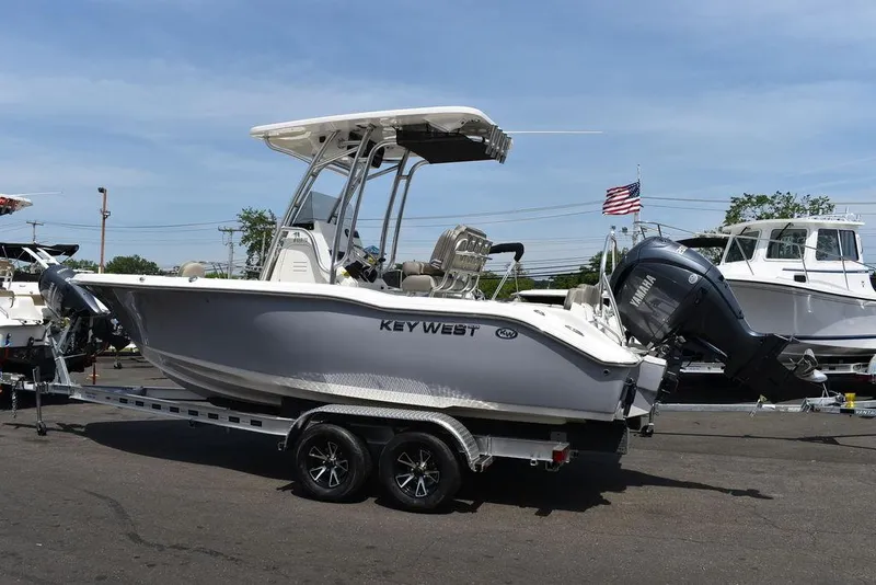Slide: The Image of 2024 Key West 219 FS boat on trailer, side view, outdoors. - 5