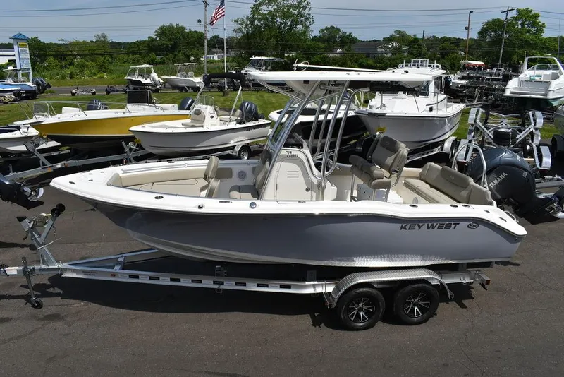 Slide: The Image of 2024 Key West 219 FS boat on trailer in marina. - 7