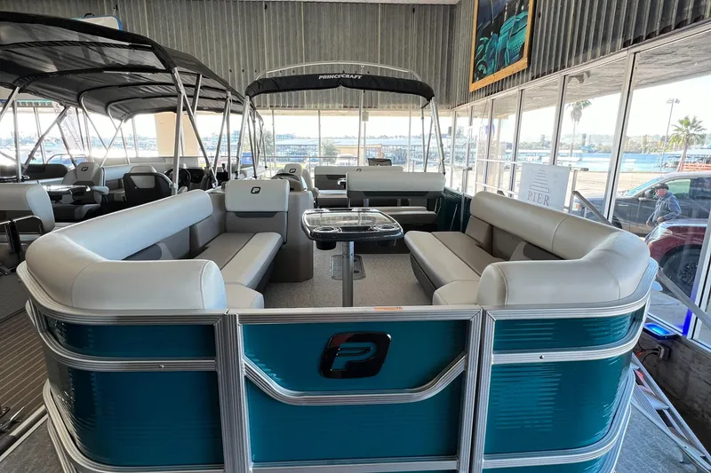 Slide: The Image of 2024 Princecraft Vectra 23 RL pontoon boat interior with seating and table setup. - 16
