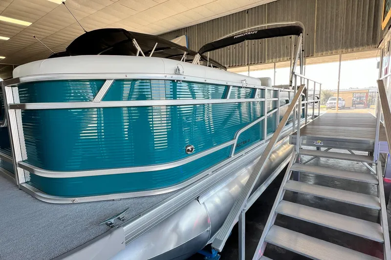 Slide: The Image of 2024 Princecraft Vectra 23 RL pontoon boat with spacious seating in a warehouse setting. - 17
