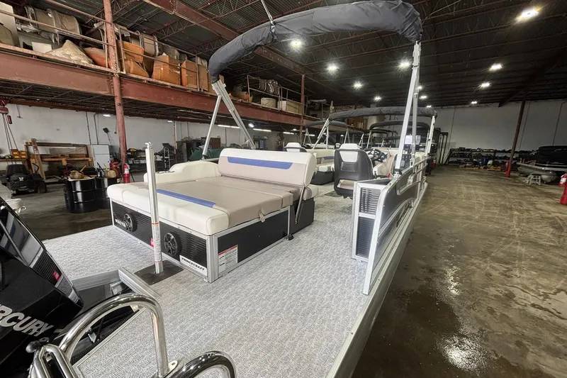 Slide: The Image of 2024 Princecraft Vectra 23 RL pontoon boat in a spacious indoor warehouse. - 18