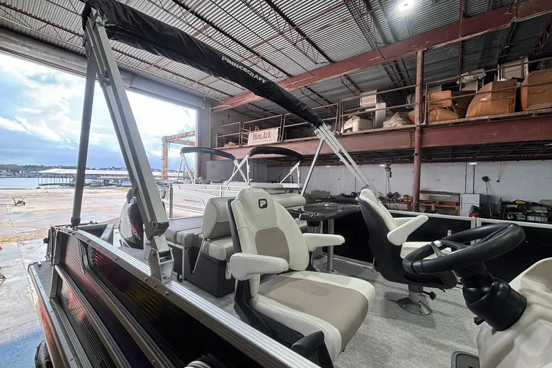 Slide: The Image of 2024 Princecraft Vectra 23 RL pontoon boat interior in a warehouse setting. - 20
