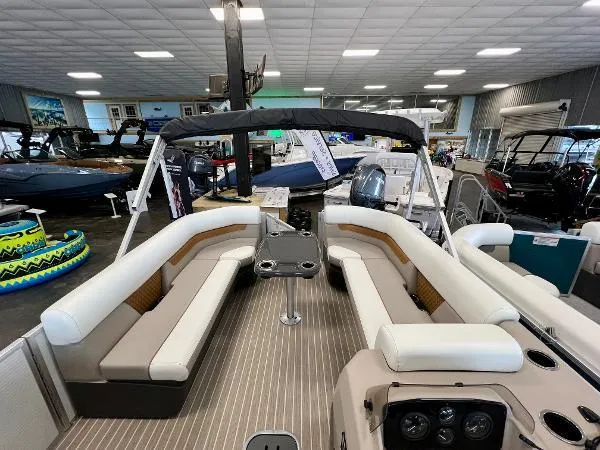 Slide: The Image of 2024 Princecraft Vectra 23 RL pontoon boat in a warehouse setting. - 4
