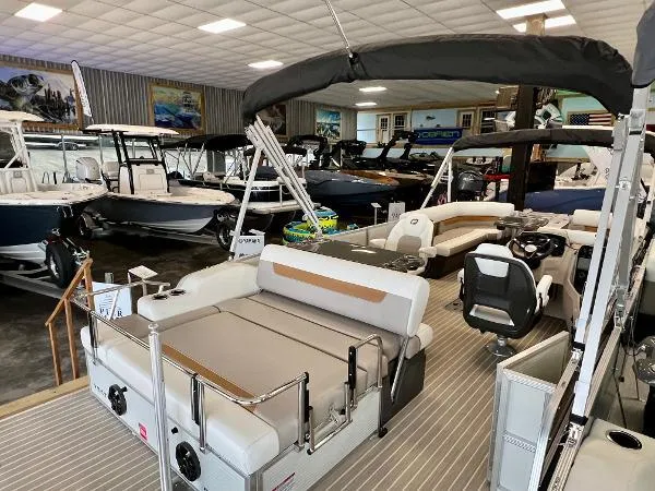 Slide: The Image of 2024 Princecraft Vectra 23 RL pontoon boat in a warehouse setting. - 7