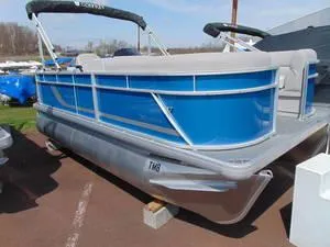 Slide: The Image of 2024 Godfrey Xperience 1680 CX 25 in. Package pontoon boat, blue and silver, docked. - 12