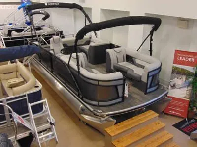 Slide: The Image of 2024 Godfrey Xperience 1680 CX 25 in. Package pontoon boat on display indoors. - 23