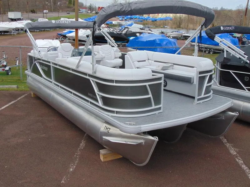 Slide: The Image of 2024 Godfrey Xperience 1680 CX 25 in. pontoon boat in a marina. - 25
