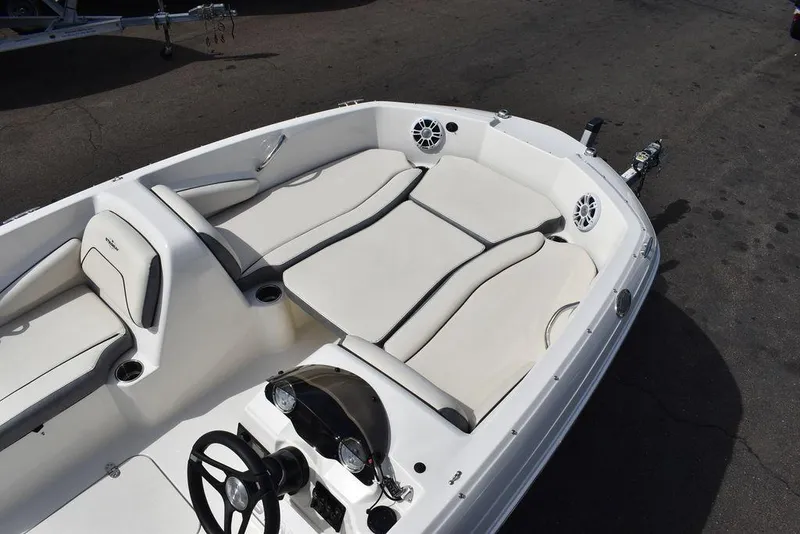 Slide: The Image of 2024 Stingray 182SC boat interior with white seating and steering console. - 11