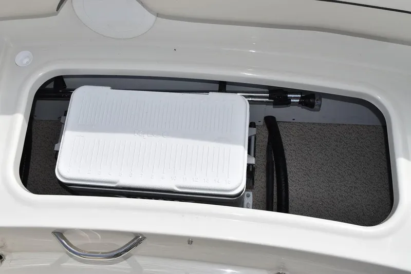Slide: The Image of Storage compartment of 2024 Stingray 182SC boat with a white cooler. - 19