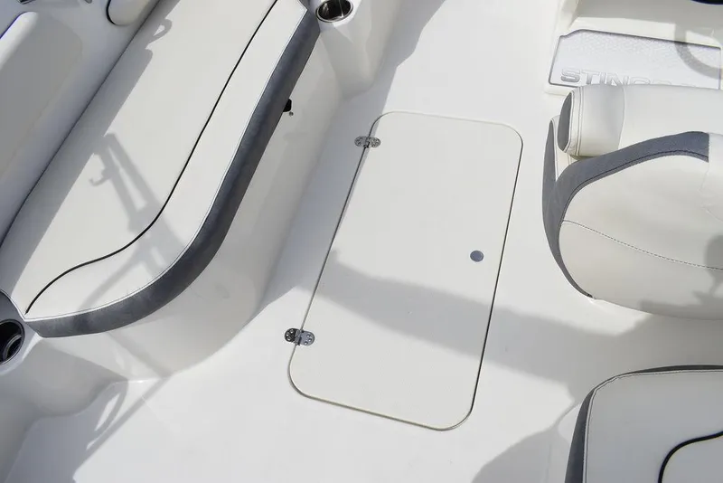 Slide: The Image of 2024 Stingray 182SC boat interior with white seating and storage compartment. - 23