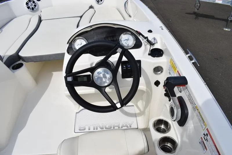 Slide: The Image of 2024 Stingray 182SC boat cockpit with steering wheel and control panel. - 27