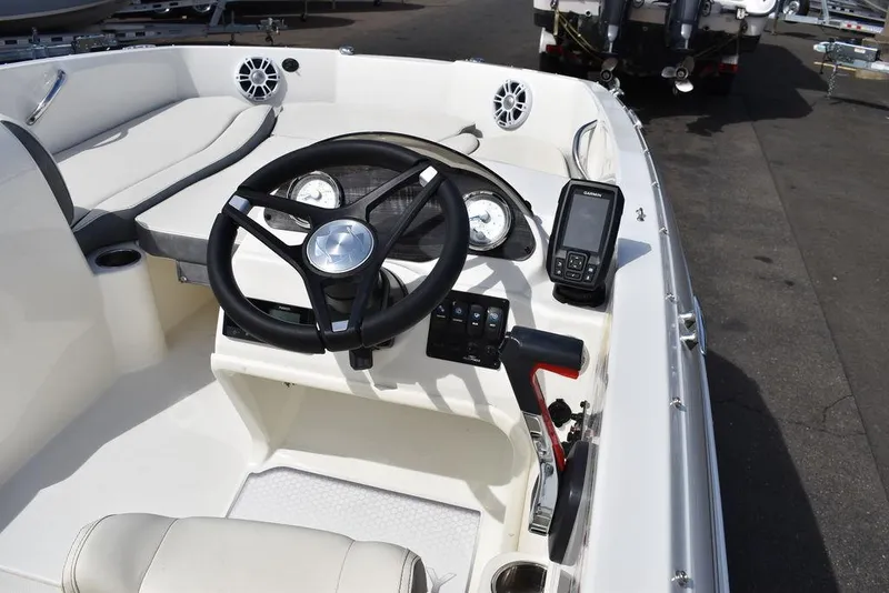 Slide: The Image of 2024 Stingray 182SC boat dashboard with steering wheel and control panel. - 28
