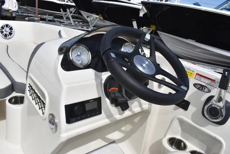 Slide: The Image of 2024 Stingray 182SC boat dashboard with steering wheel and control panel. - 34