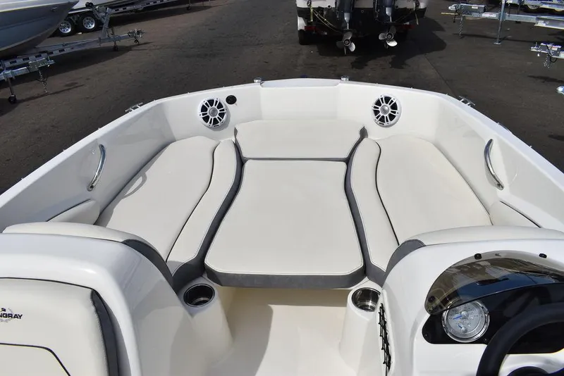 Slide: The Image of 2024 Stingray 182SC boat interior with white cushioned seating and cup holders. - 35