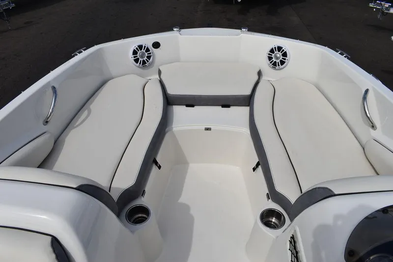 Slide: The Image of 2024 Stingray 182SC boat interior with cushioned seating and cup holders. - 37