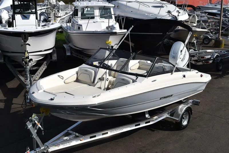The Image of 2024 Stingray 191DC boat on a trailer in a marina. - 0