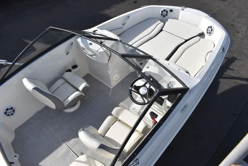 Slide: The Image of 2024 Stingray 191DC boat interior with white seating and steering console. - 10
