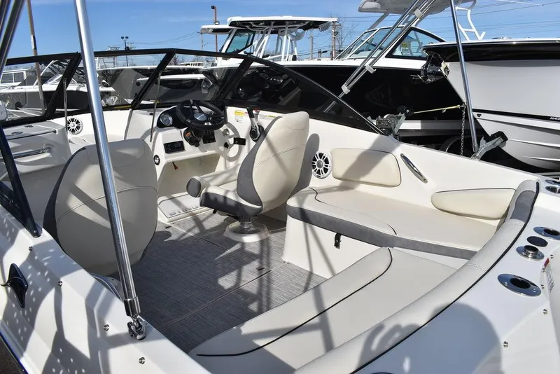 Slide: The Image of 2024 Stingray 191DC boat interior with beige seating and modern dashboard. - 11