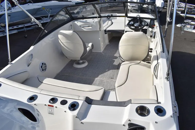 Slide: The Image of 2024 Stingray 191DC boat interior with seating and steering wheel. - 13