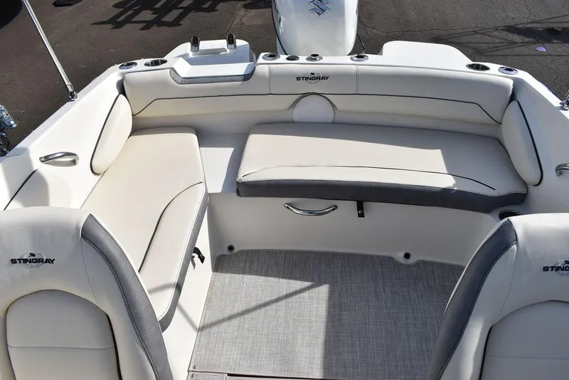 Slide: The Image of 2024 Stingray 191DC boat interior with white and gray seating. - 14