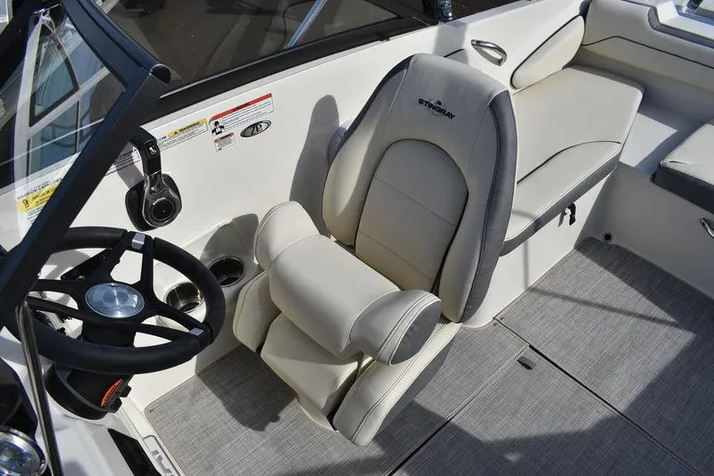 Slide: The Image of 2024 Stingray 191DC boat interior with captain's chair and steering wheel. - 19