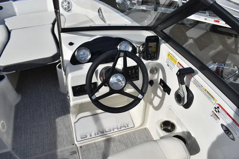 Slide: The Image of 2024 Stingray 191DC boat cockpit with steering wheel and control panel. - 20