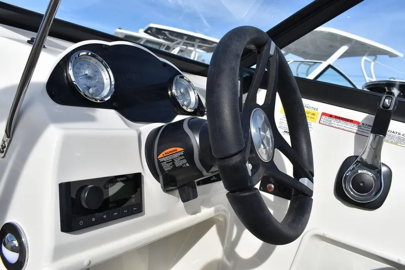 Slide: The Image of 2024 Stingray 191DC boat dashboard with steering wheel and control panel. - 25