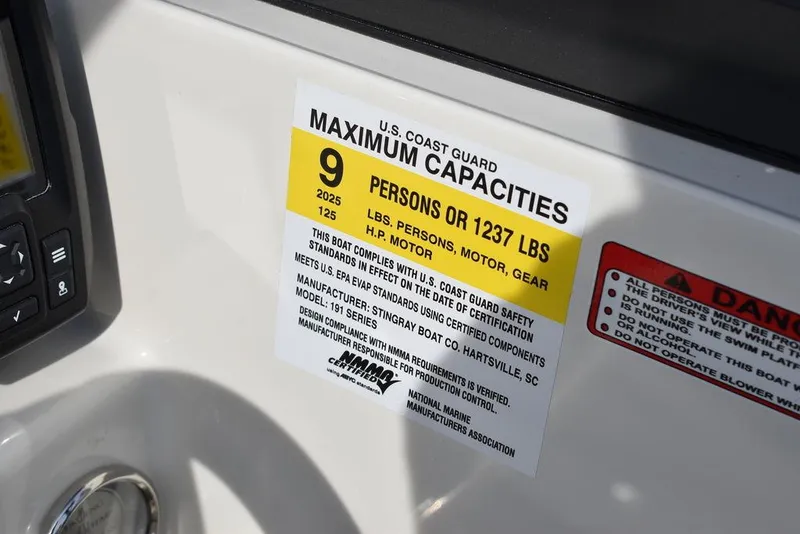 Slide: The Image of 2024 Stingray 191DC boat capacity label, 9 persons or 1237 lbs, U.S. Coast Guard compliant. - 26