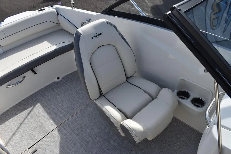 Slide: The Image of 2024 Stingray 191DC boat interior with plush seating and cup holders. - 27