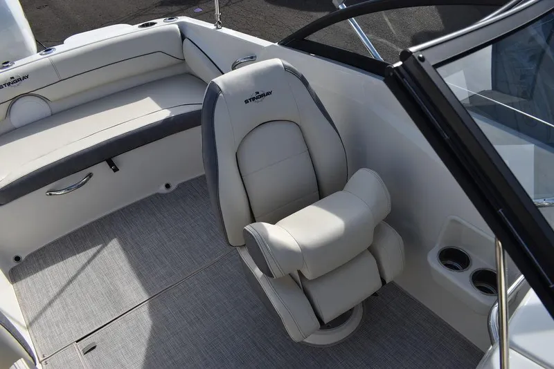 Slide: The Image of 2024 Stingray 191DC boat interior with captain's chair and rear seating. - 28