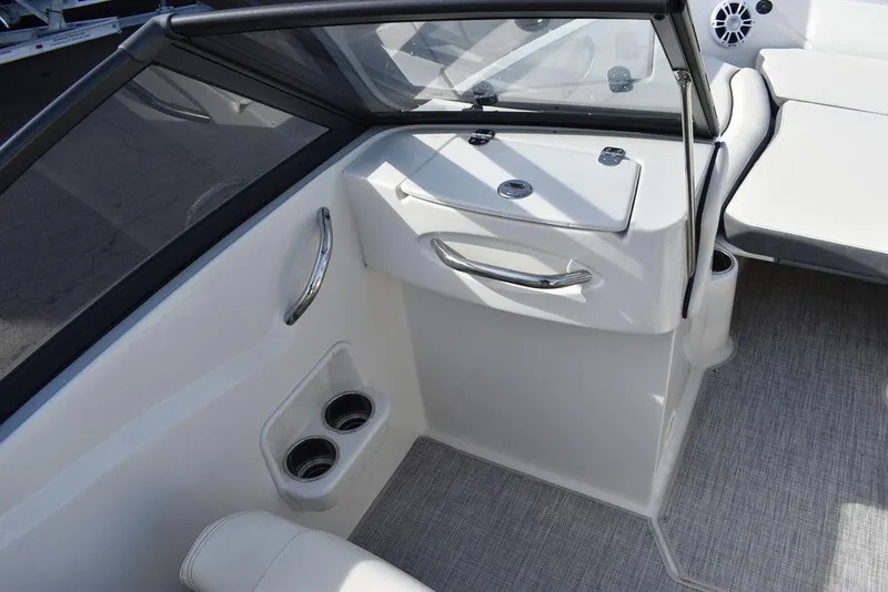 Slide: The Image of 2024 Stingray 191DC boat interior with cup holders and storage compartment. - 29