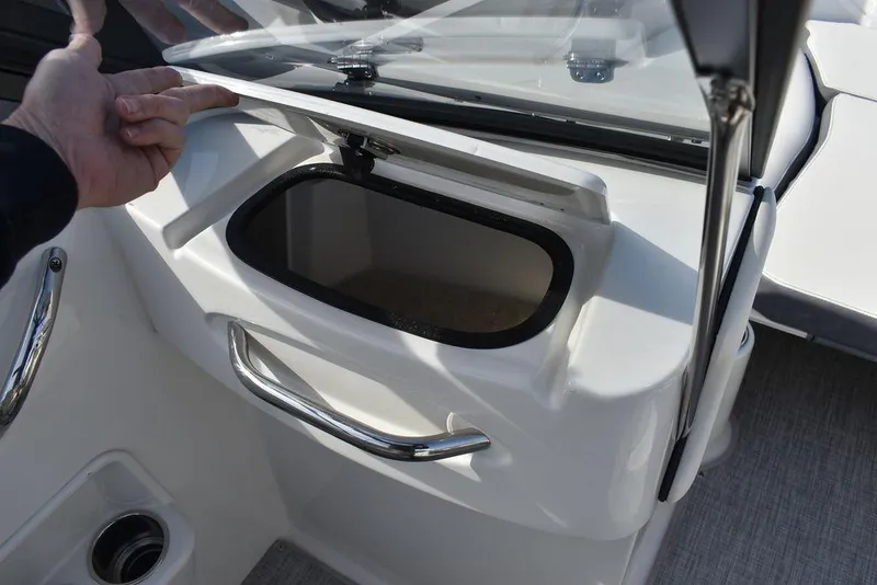 Slide: The Image of 2024 Stingray 191DC boat storage compartment with open lid. - 30