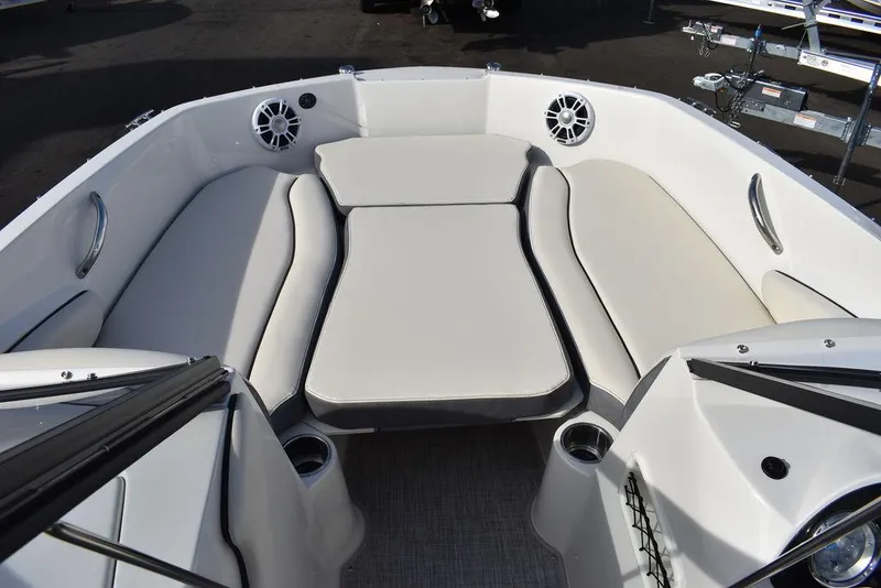 Slide: The Image of 2024 Stingray 191DC boat interior with cushioned seating and cup holders. - 31