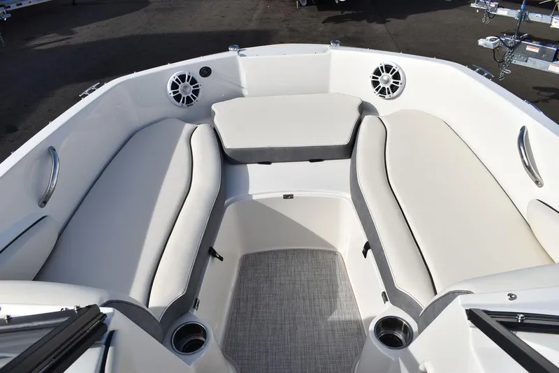 Slide: The Image of 2024 Stingray 191DC boat interior with cushioned seating and cup holders. - 34
