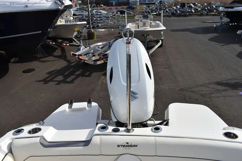 Slide: The Image of 2024 Stingray 191DC boat with outboard motor at a marina. - 40