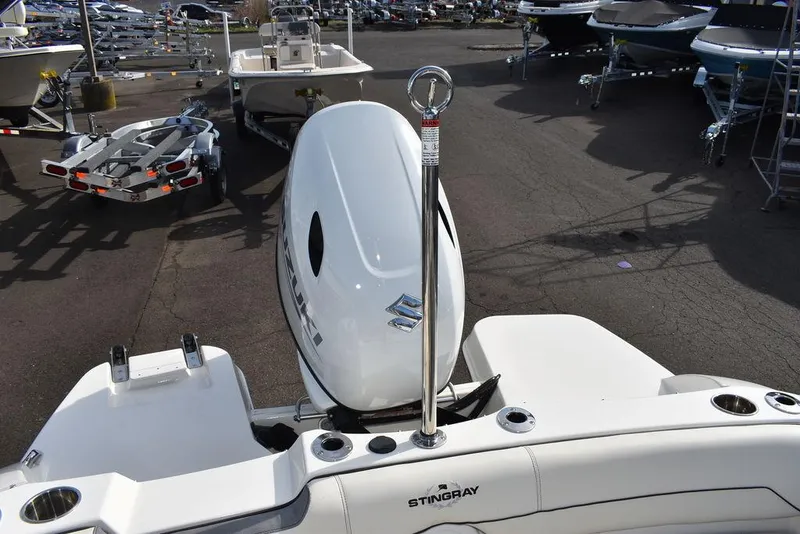 Slide: The Image of 2024 Stingray 191DC boat with Suzuki outboard motor in a marina. - 41