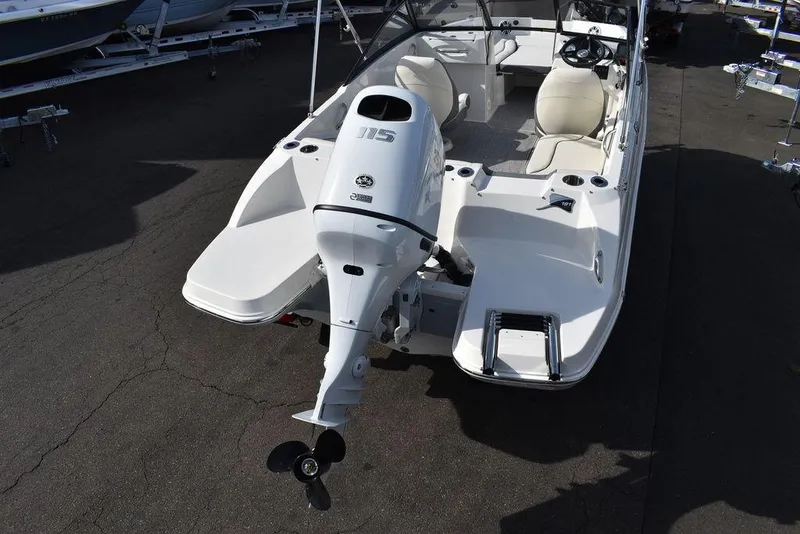 Slide: The Image of 2024 Stingray 191DC boat with outboard motor, white interior, and seating arrangement. - 5