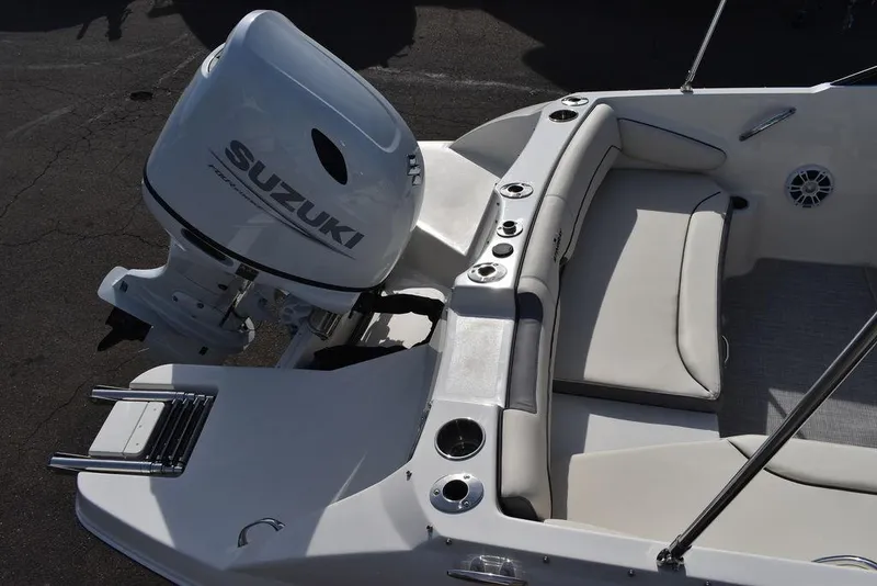 Slide: The Image of 2024 Stingray 191DC boat with Suzuki outboard motor and white seating. - 7