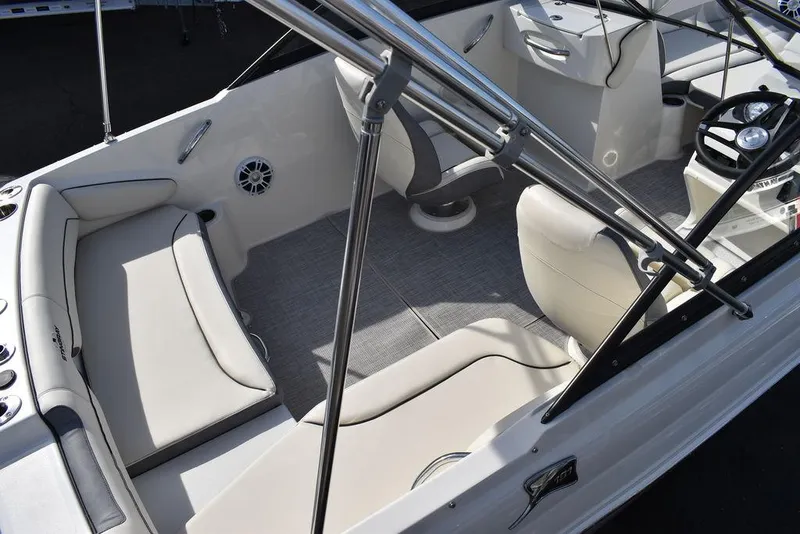 Slide: The Image of 2024 Stingray 191DC boat interior with seating and steering console. - 8