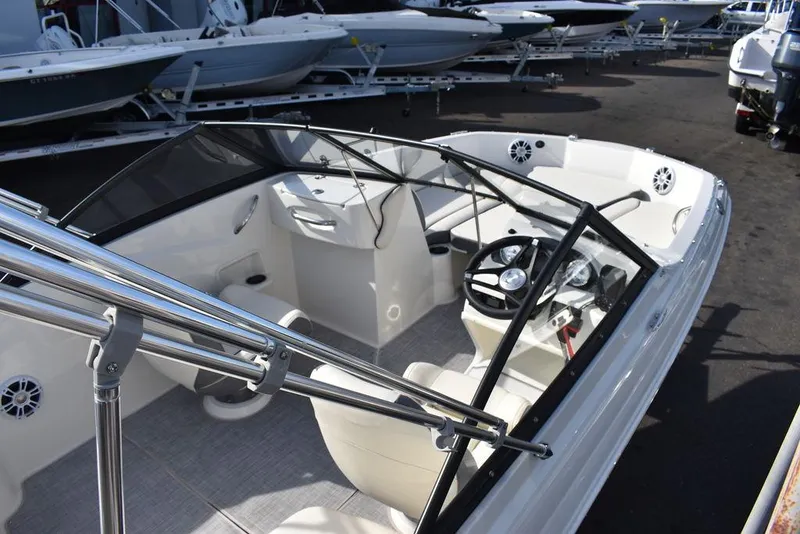 Slide: The Image of 2024 Stingray 191DC boat interior with steering wheel and seating. - 9
