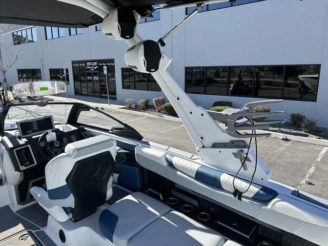 Slide: The Image of 2024 Malibu M220 boat interior with modern seating and advanced control panel. - 13