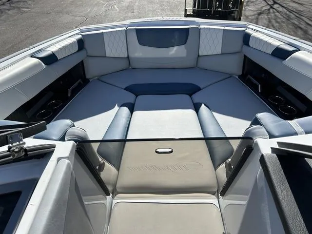 Slide: The Image of 2024 Malibu M220 boat interior with luxurious seating and cup holders. - 14