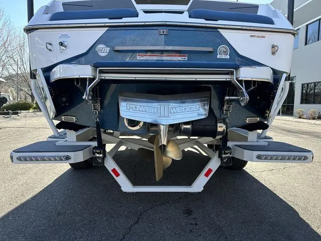 Slide: The Image of 2024 Malibu M220 boat rear view showcasing Power Wedge III and propeller. - 5