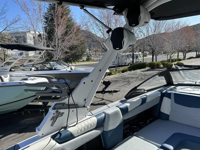 Slide: The Image of 2024 Malibu M220 boat interior with wakeboard tower and seating. - 7
