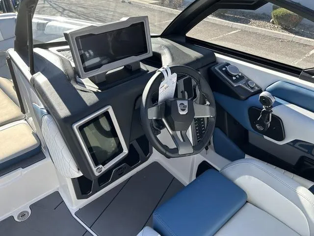 Slide: The Image of 2024 Malibu M220 boat dashboard with touchscreen controls and steering wheel. - 8